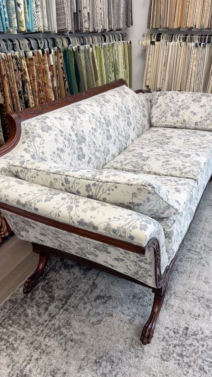 A couch is sitting on top of a rug in a room.