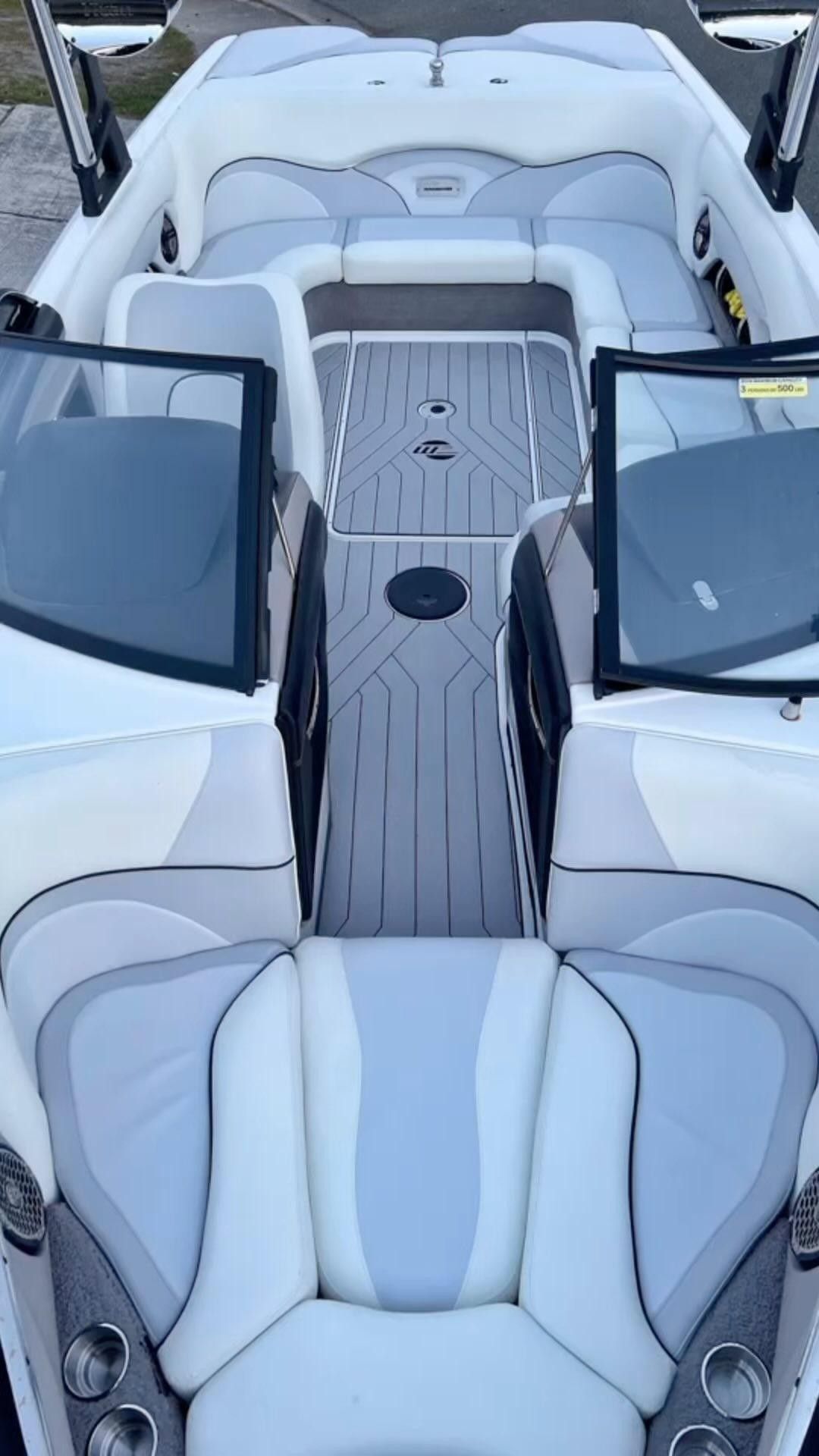 A white and gray boat is parked in a dock.