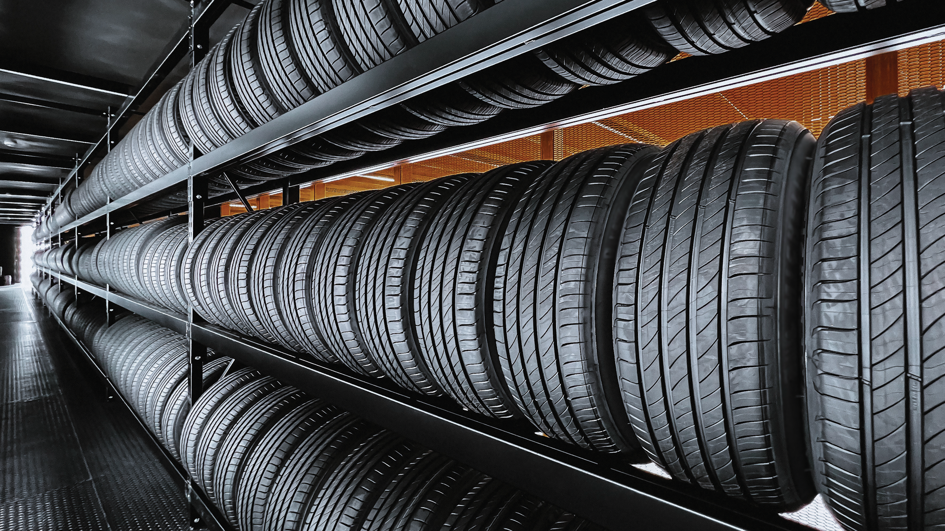 A warehouse filled with lots of tires on shelves.