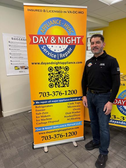 A man is standing in front of a sign that says day and night service repair