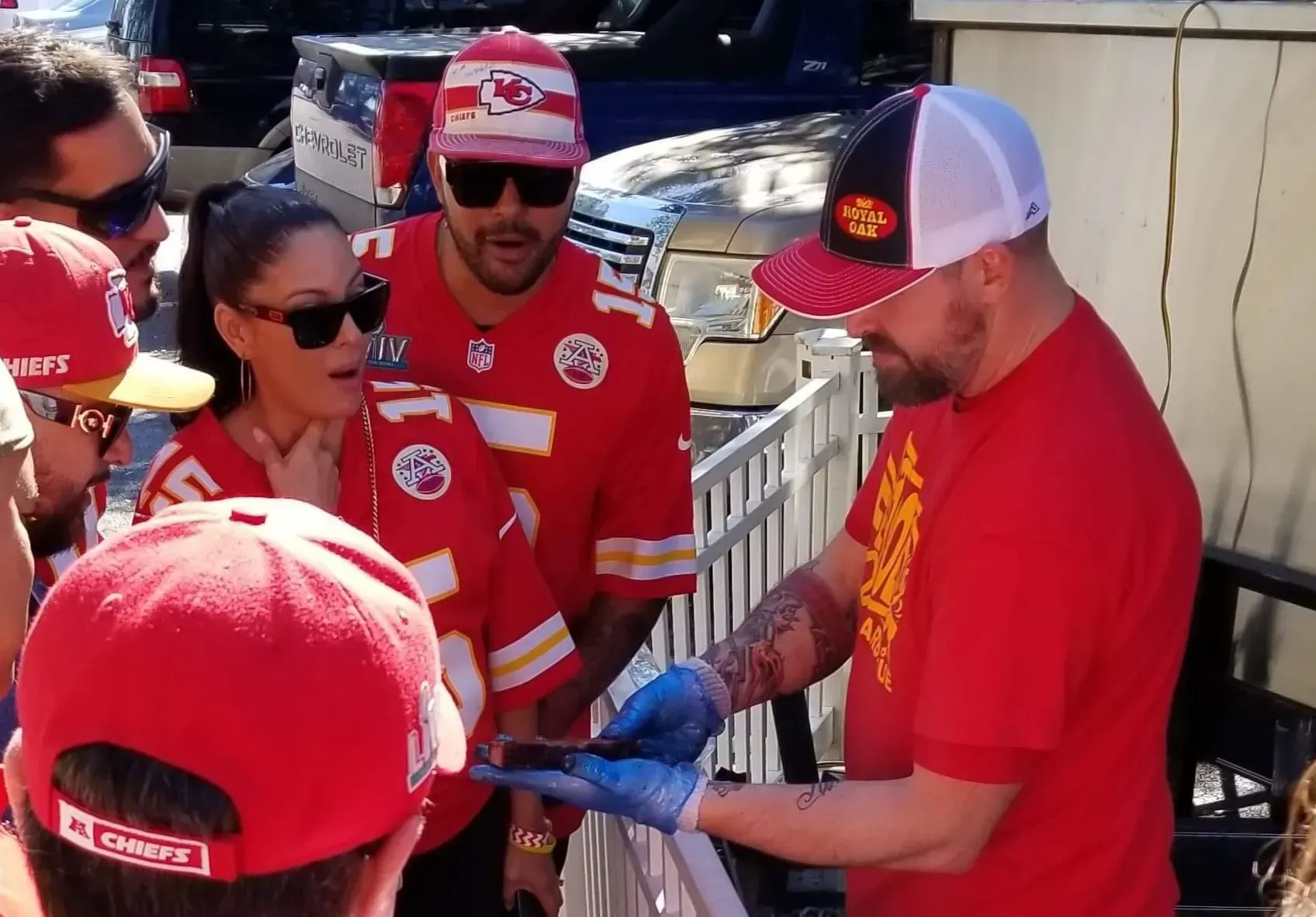 A man in a red shirt that says chiefs on it