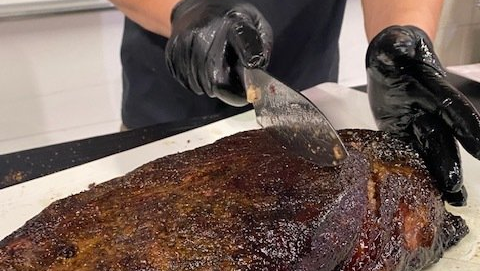 slicing a smoked brisket