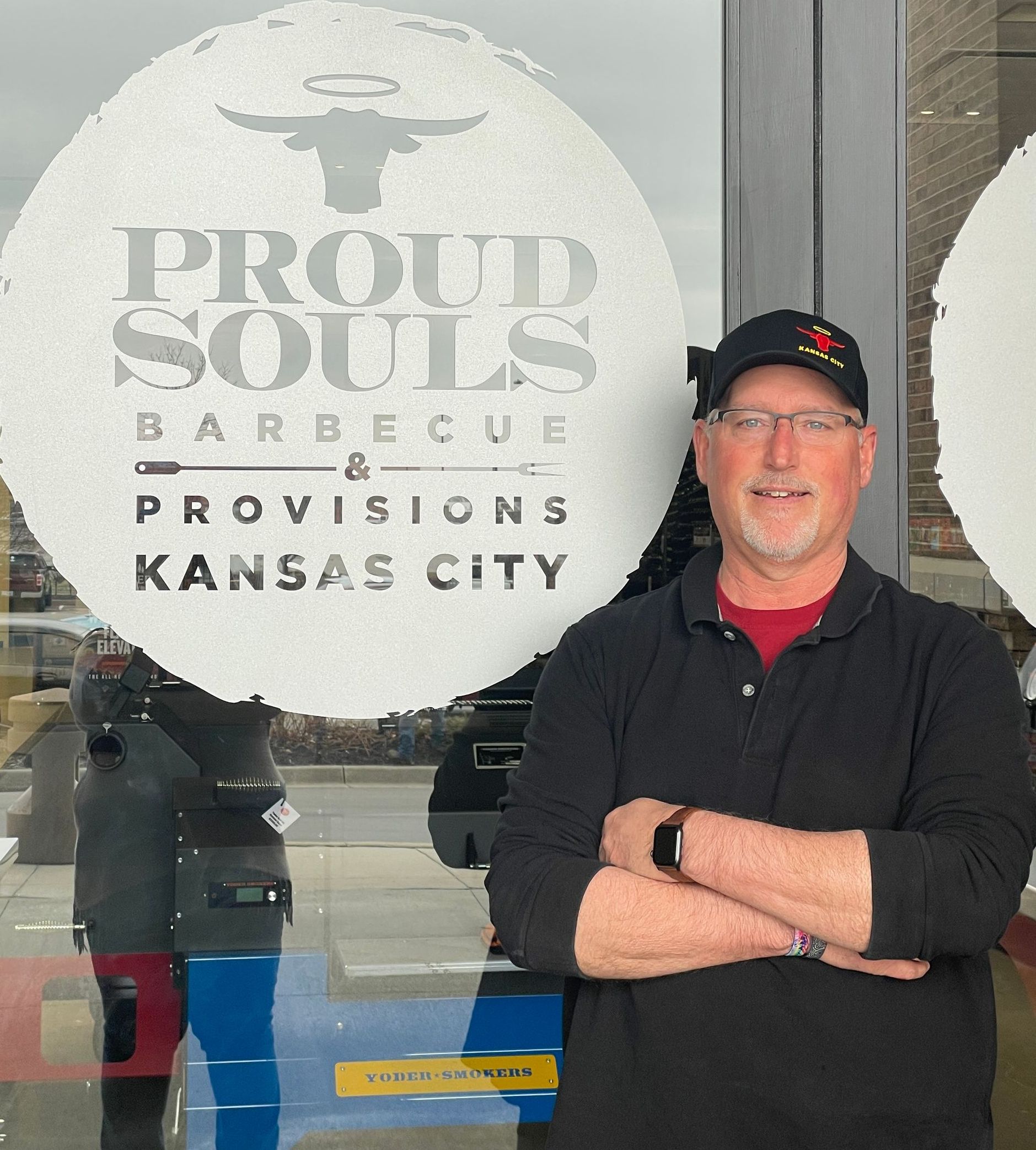 A man standing in front of a sign that says proud souls barbecue