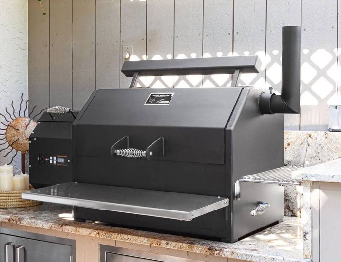 A black grill is sitting on top of a counter.