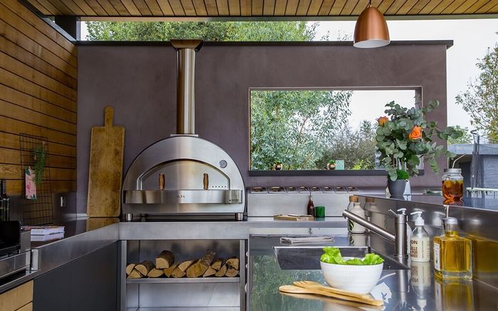 A kitchen with a stainless steel oven and a sink.