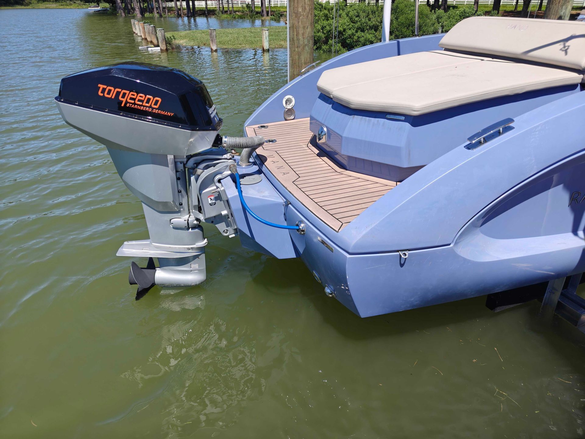 Torqeedo electric outboard on Rand Mana23 periwinkle