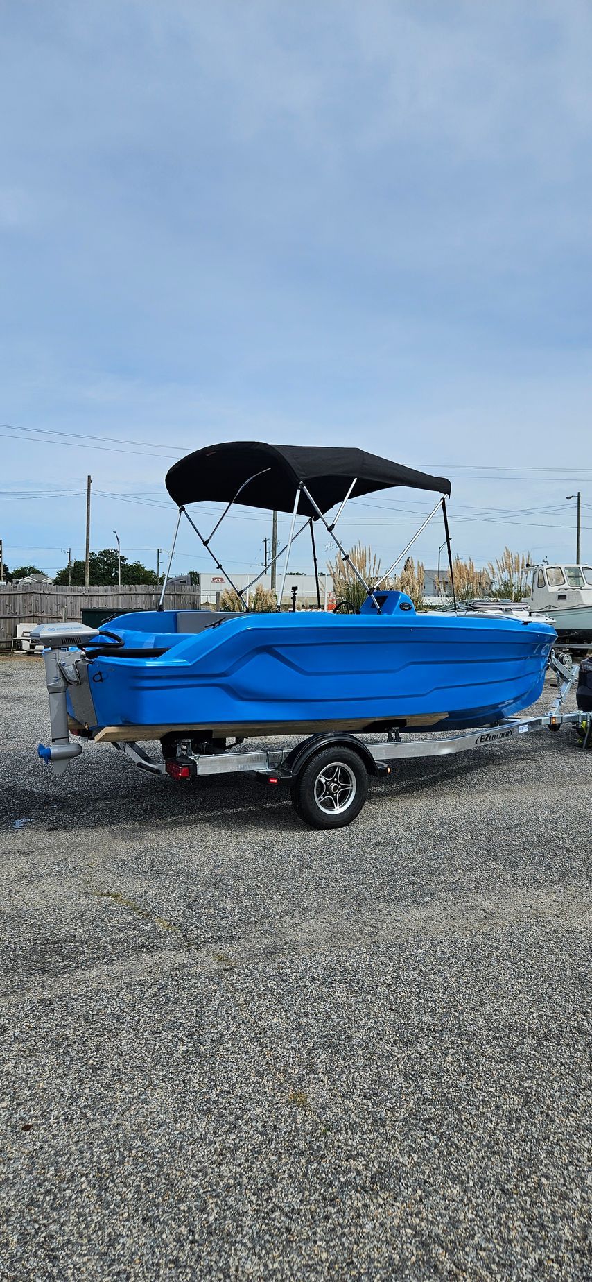 Blue Phantom plastic boat with canopy top - side back