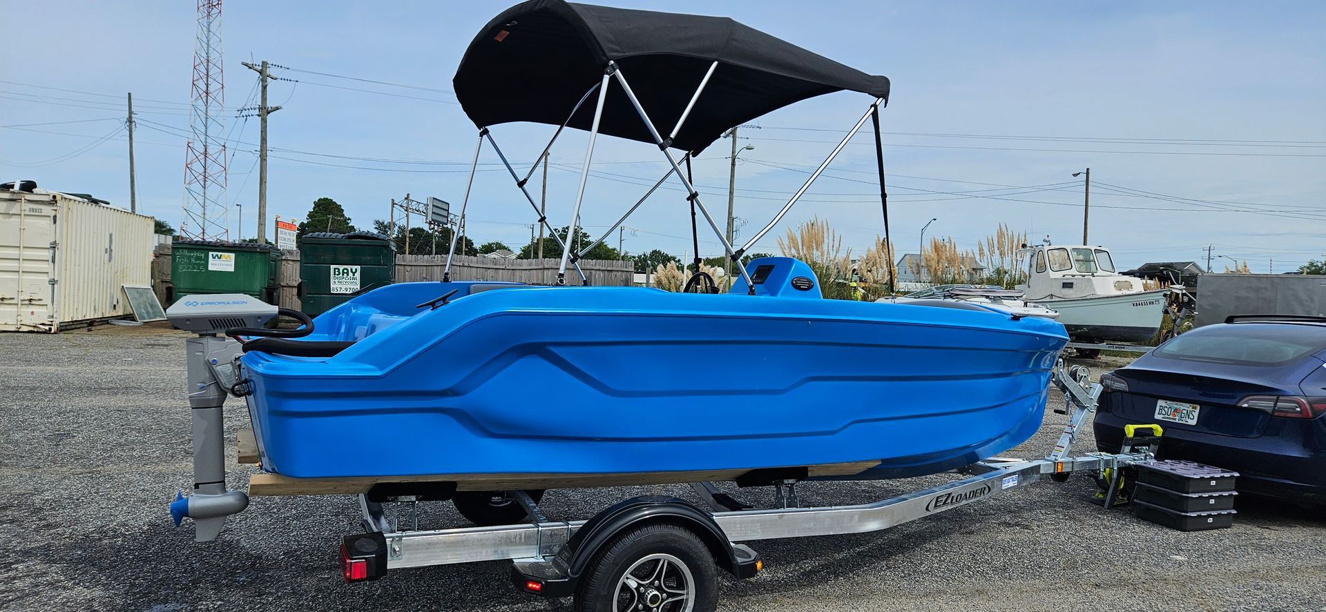 Blue Phantom plastic boat with canopy top - on trailer