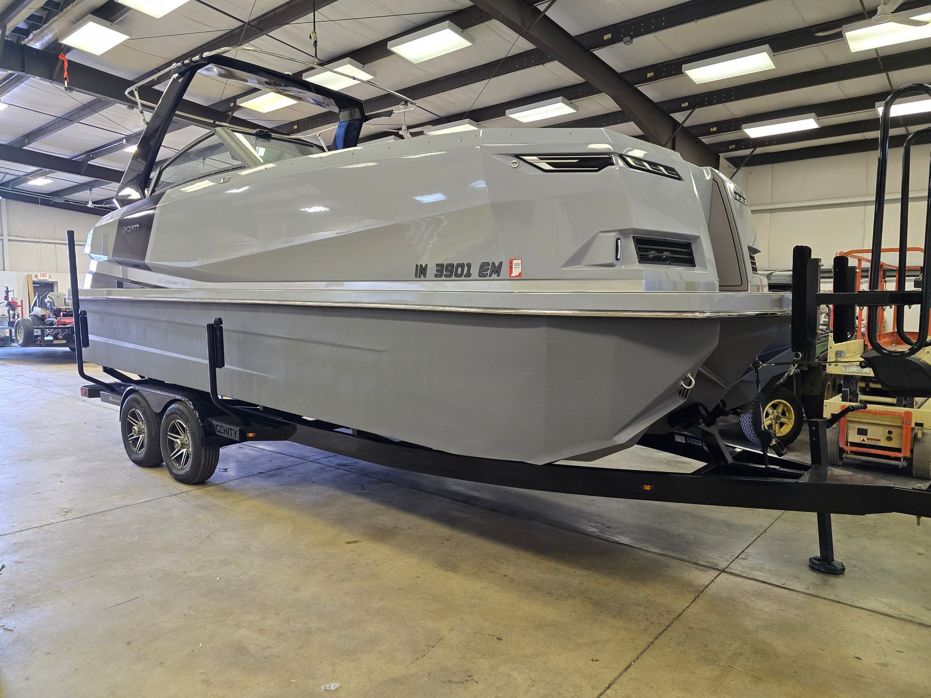 Gray Ingenity 23e boat with on trailer - port side