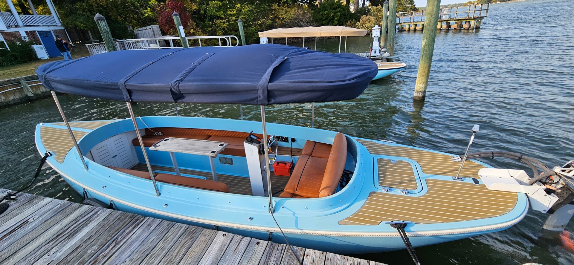 Blue Fantail boat with blue canopy top - port side