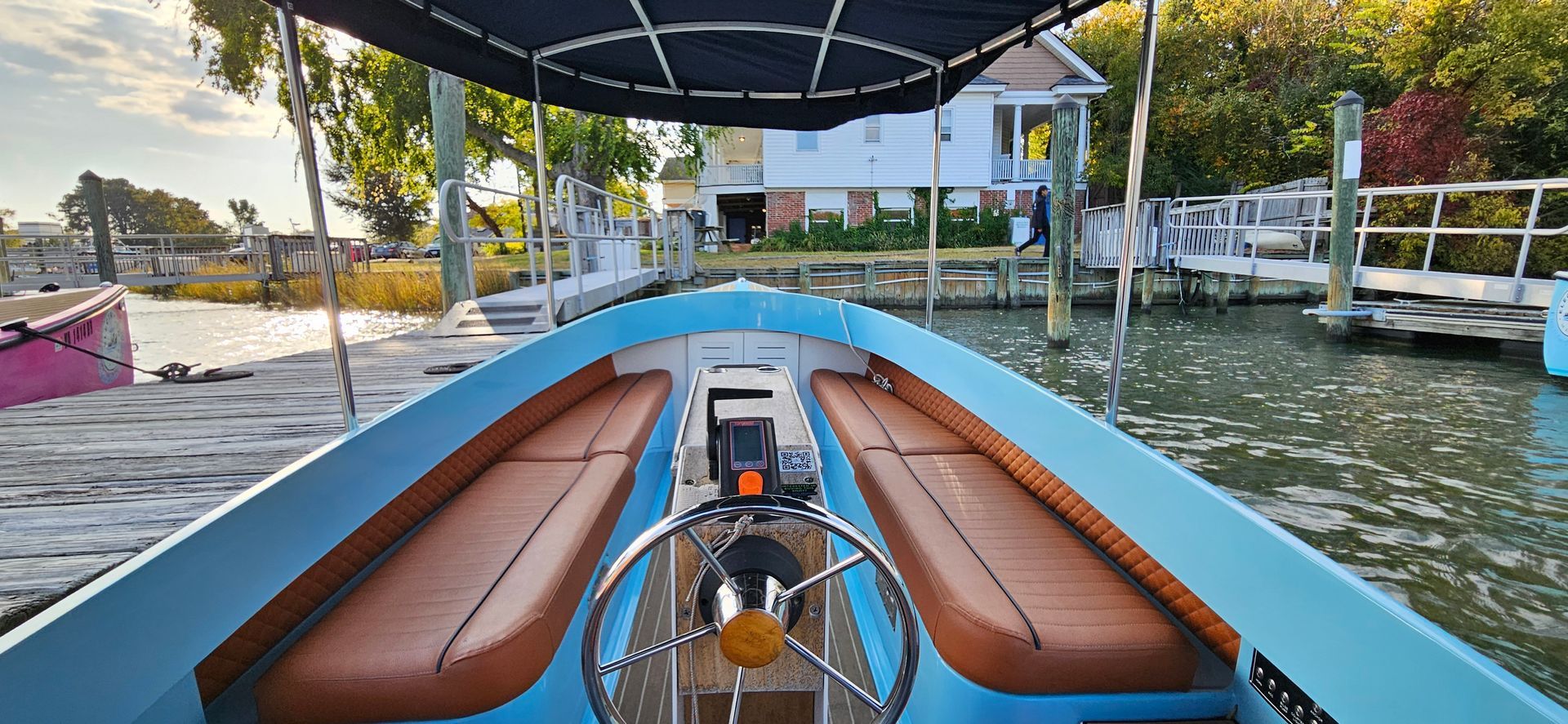 Blue Fantail boat with blue canopy top - helm