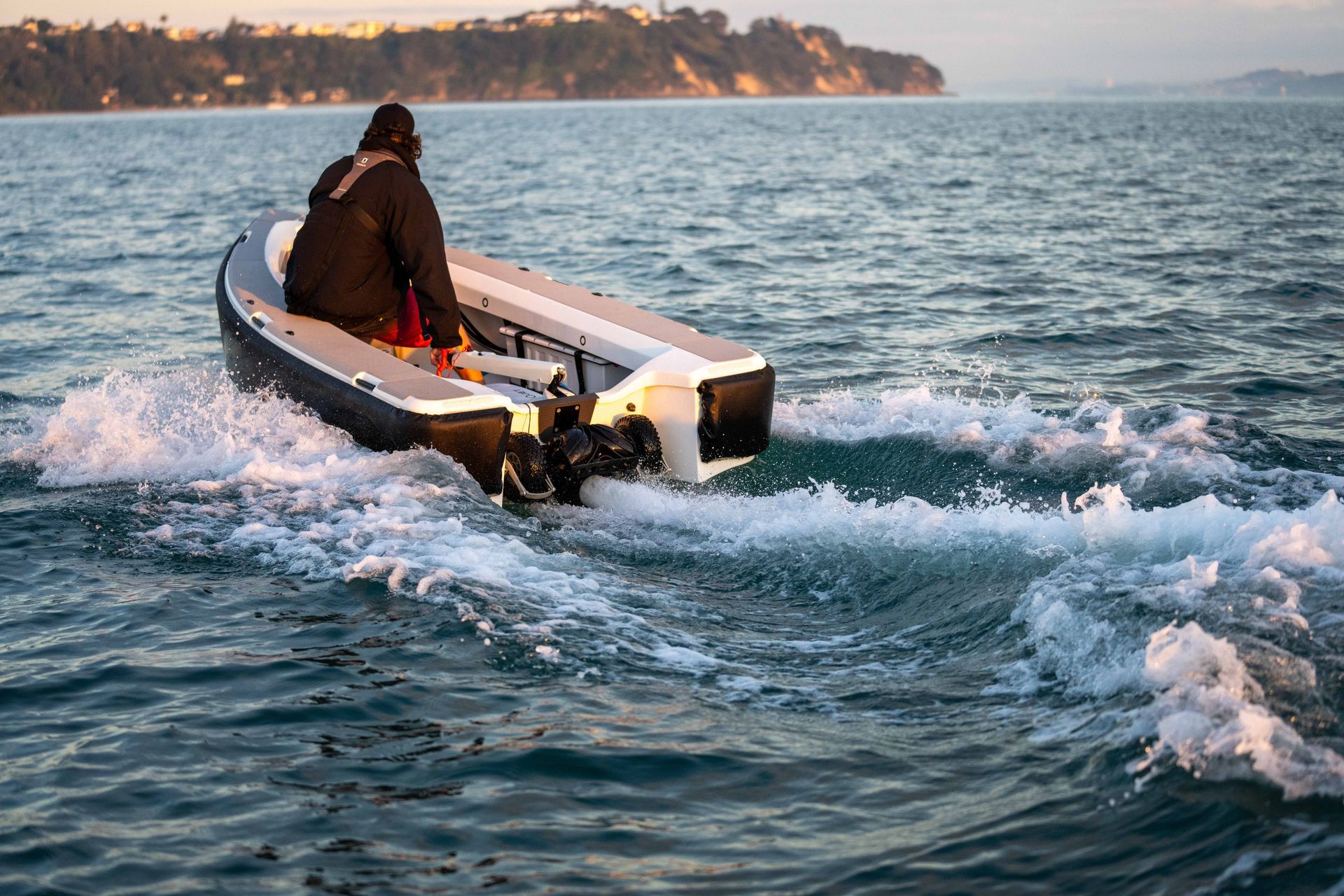 Male riding the ZeroJet Powered OC tender  in the ocean