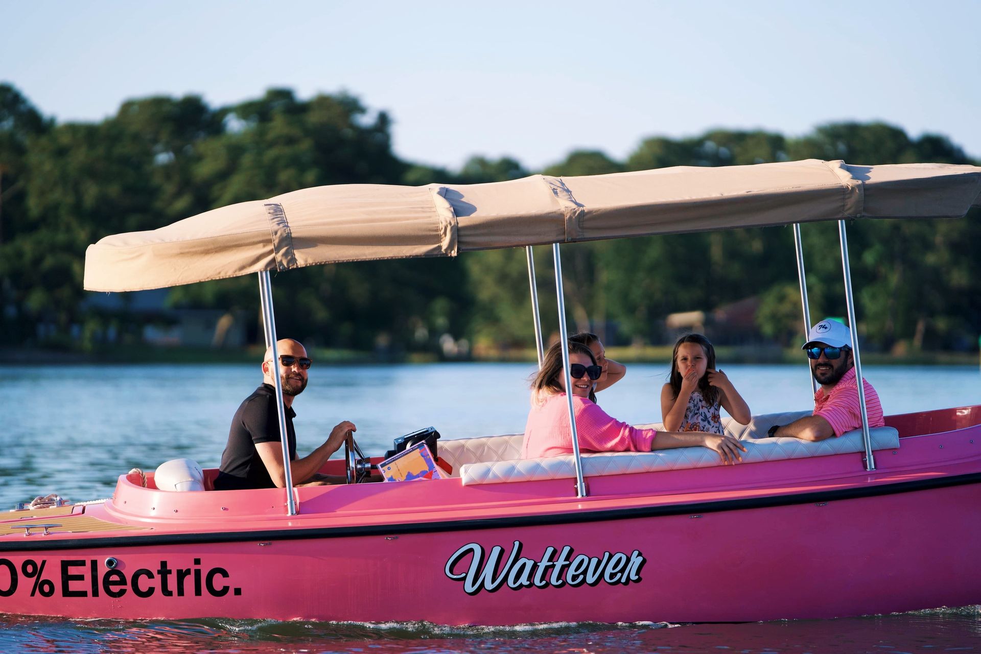 A happy family aboard a gray boat