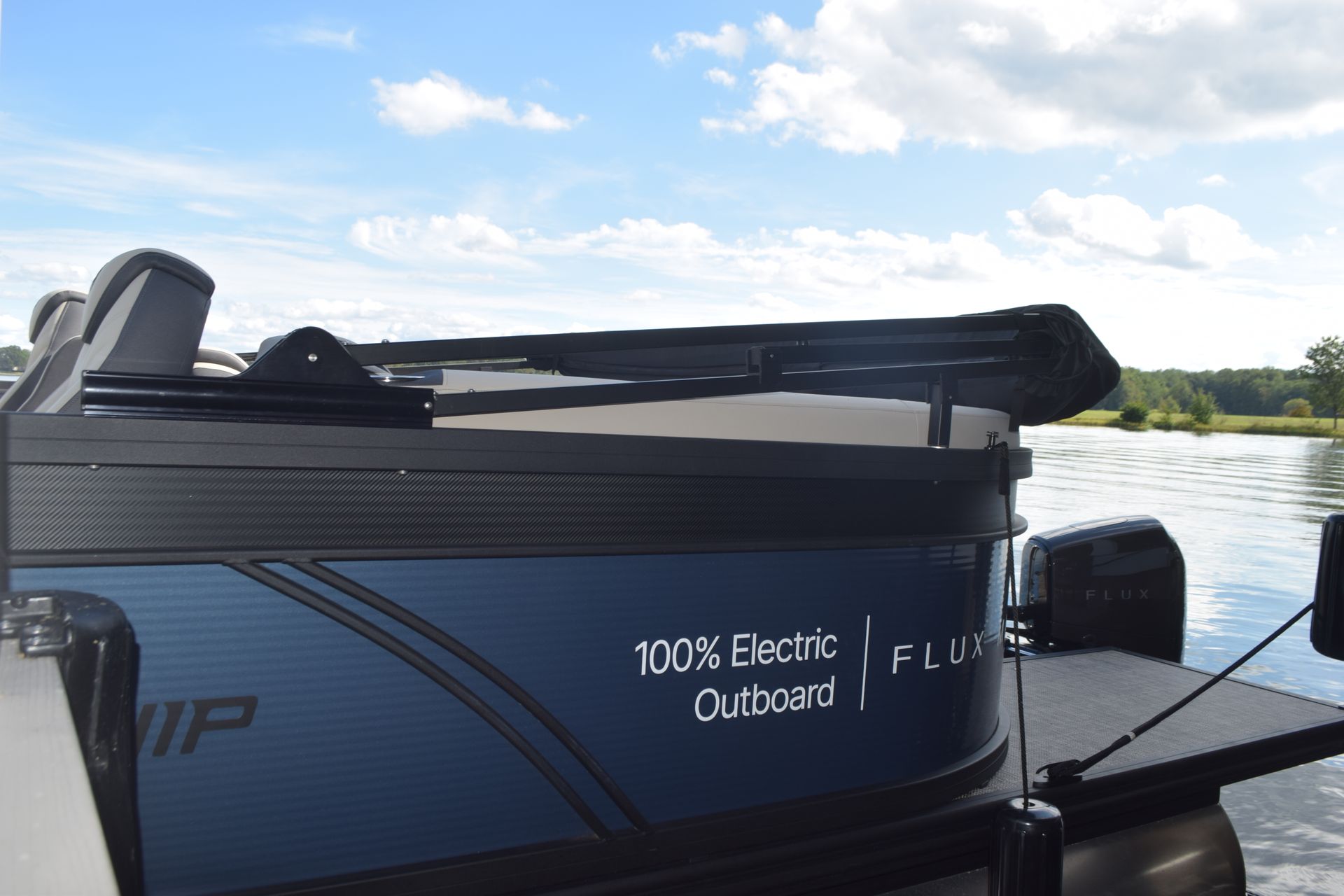 exterior stern of flagship discover pontoon with bimini top down and extended swim platform