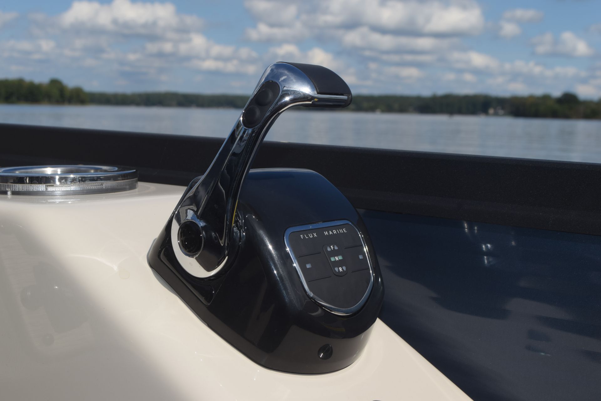 Throttle on flagship discover pontoon with lake in background