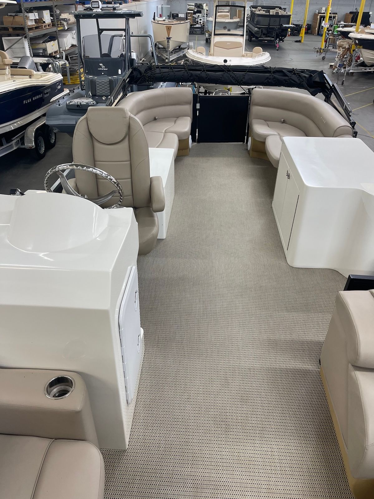 Layout of deck on tritoon with beige interior the helm station is on the starboard side