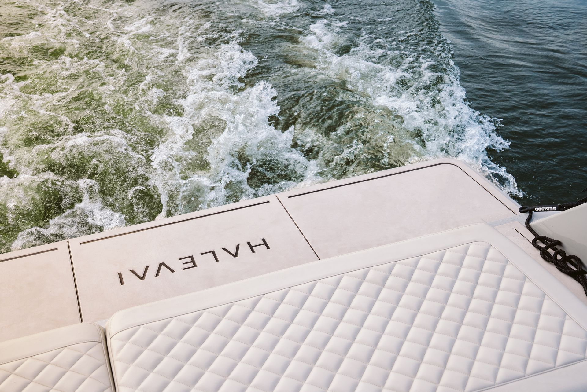 Transom of Halevai model2050 electric boat cruising speeds cream cushions