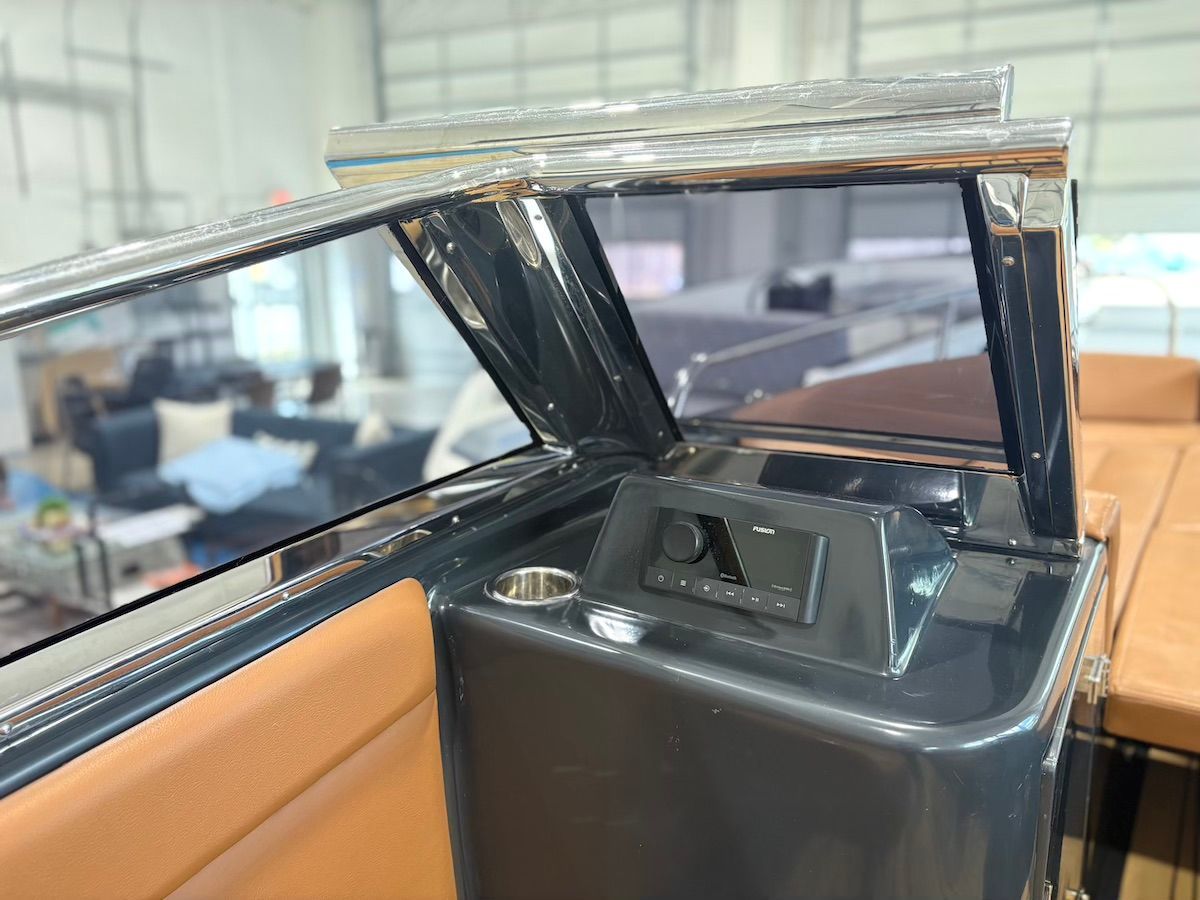 Port side boat with fushion audio system and matt black and cupholder brown interior 