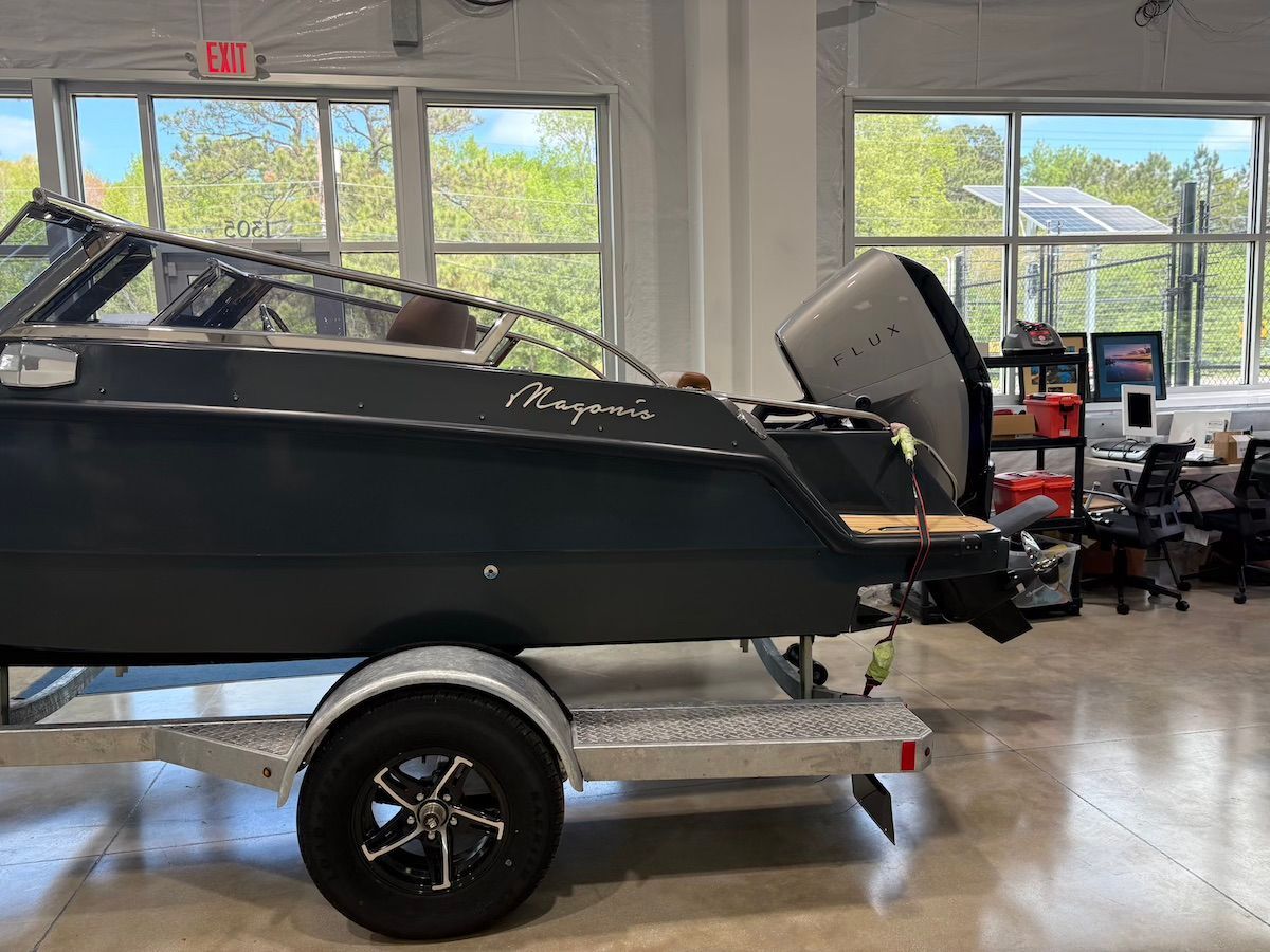 Back of magonis with Flux motor and wood teak flooring in a large showroom 