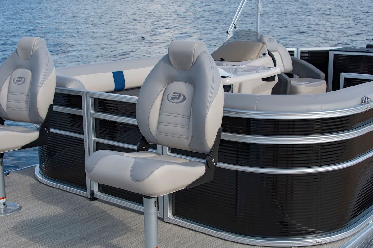 Bow of a pontoon with captain chair upfront for fishing there is a gate behind the chair to enter the rest of the pontoon