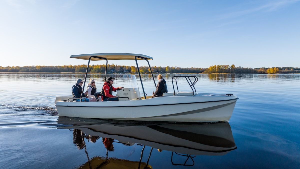People enjoying time together on boat center console two in back one in captain and one up front