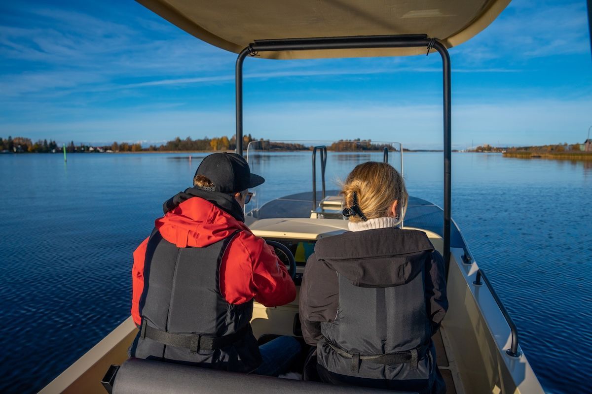 two people on board at captain seat of Amber solar electric boat from Elvene