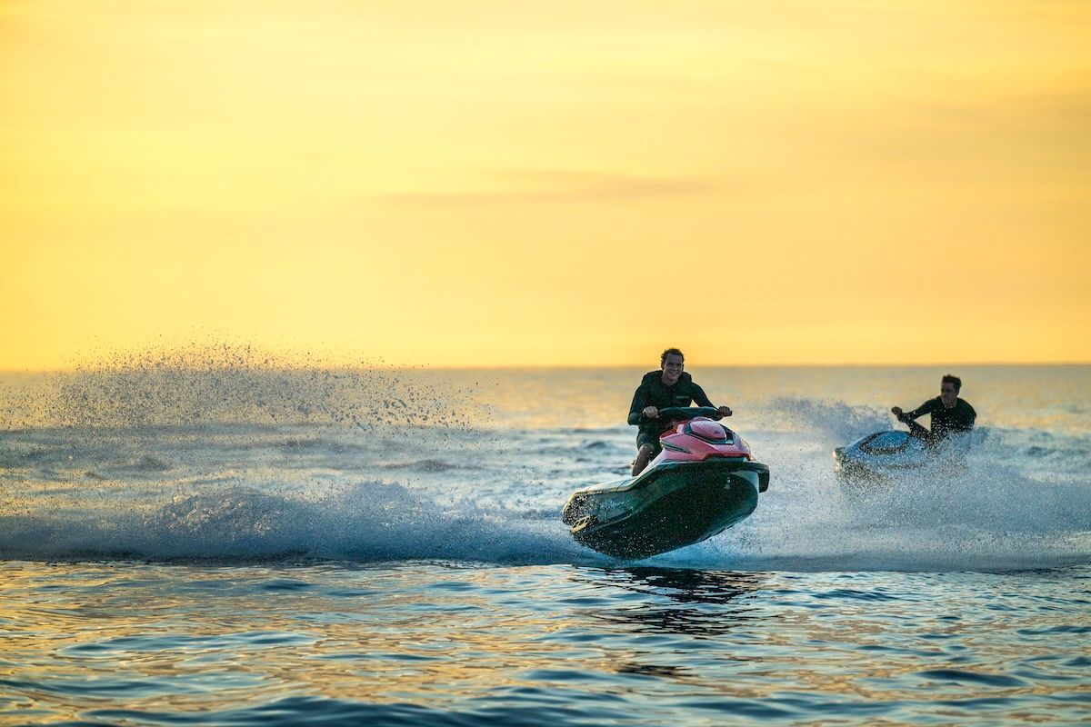 Two jet skis are sitting next to each other in the water.