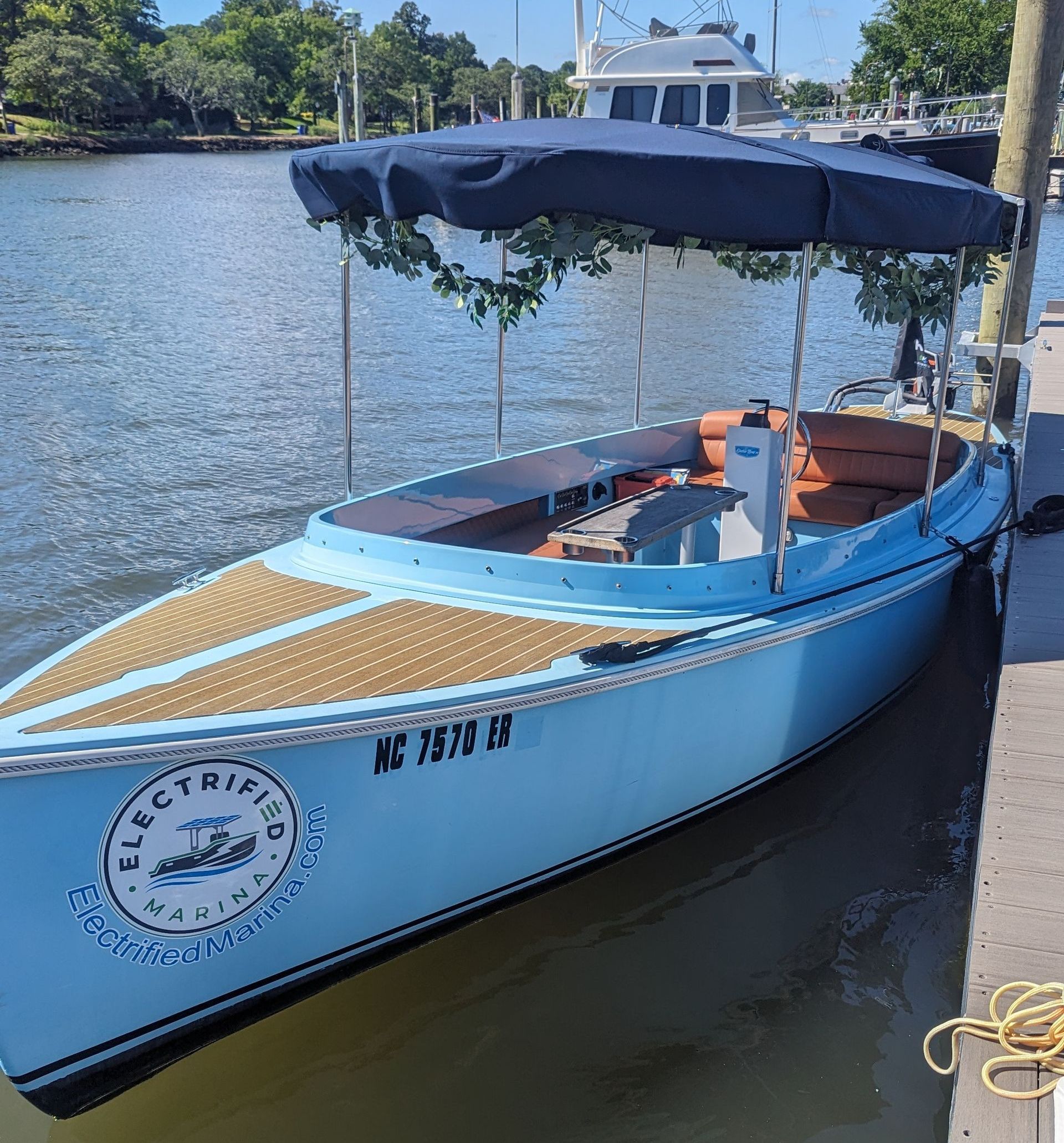 Ingenity boat with 2 ladies on the back transom 