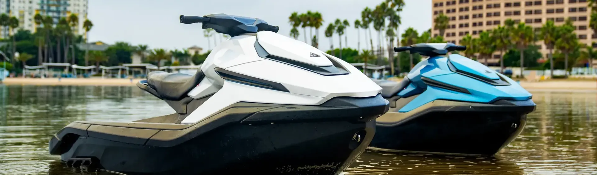 Two jet skis are sitting next to each other in the water.