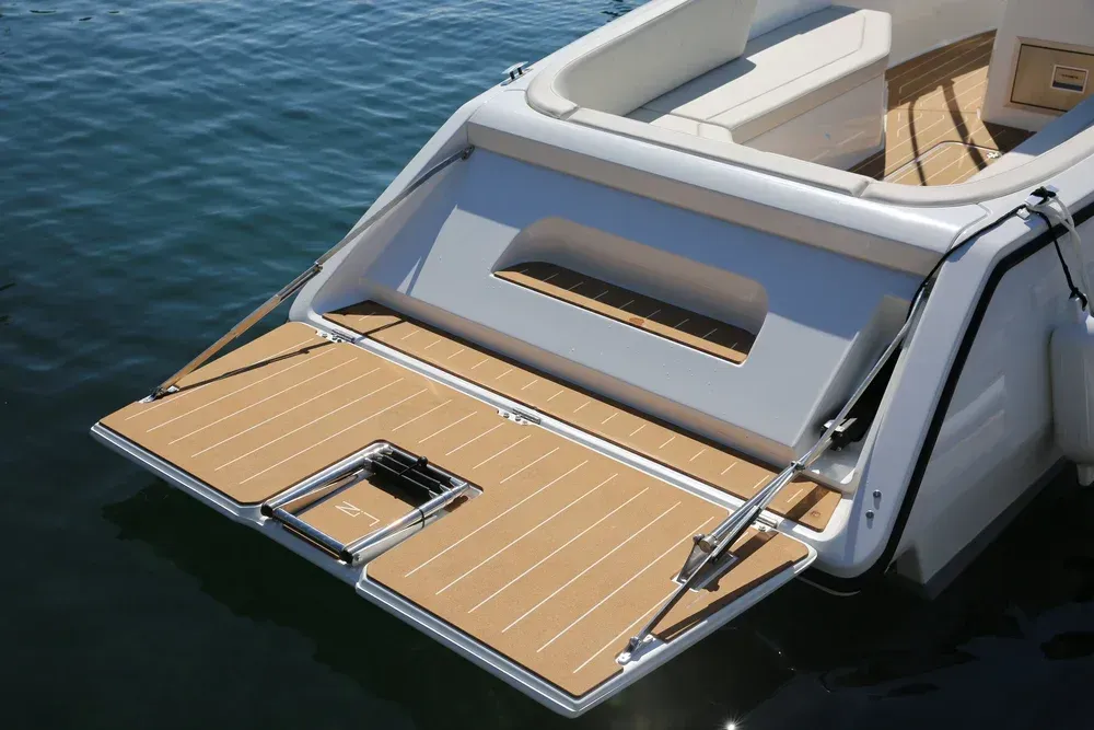 single rider in center console solar electric boat and day cruiser fall foilage in background