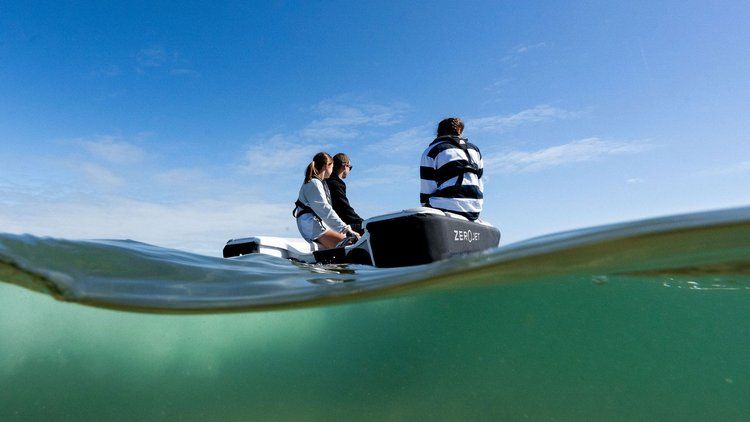 offshore cruising tender powered by ZeroJet three people on boat in water