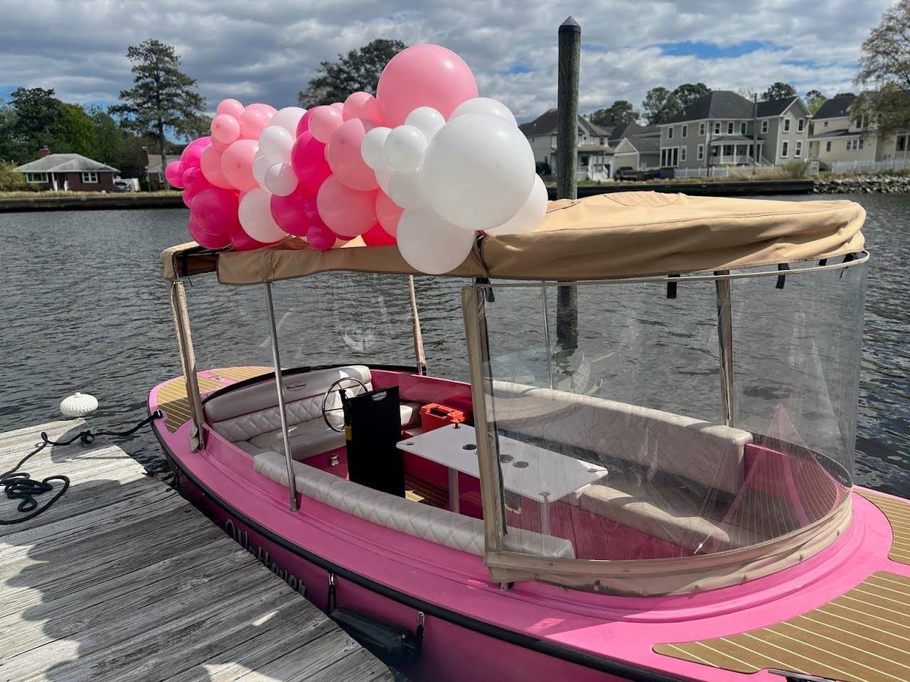 Pink Fantail boat with canopy top  and enclosure with balloons- Front side