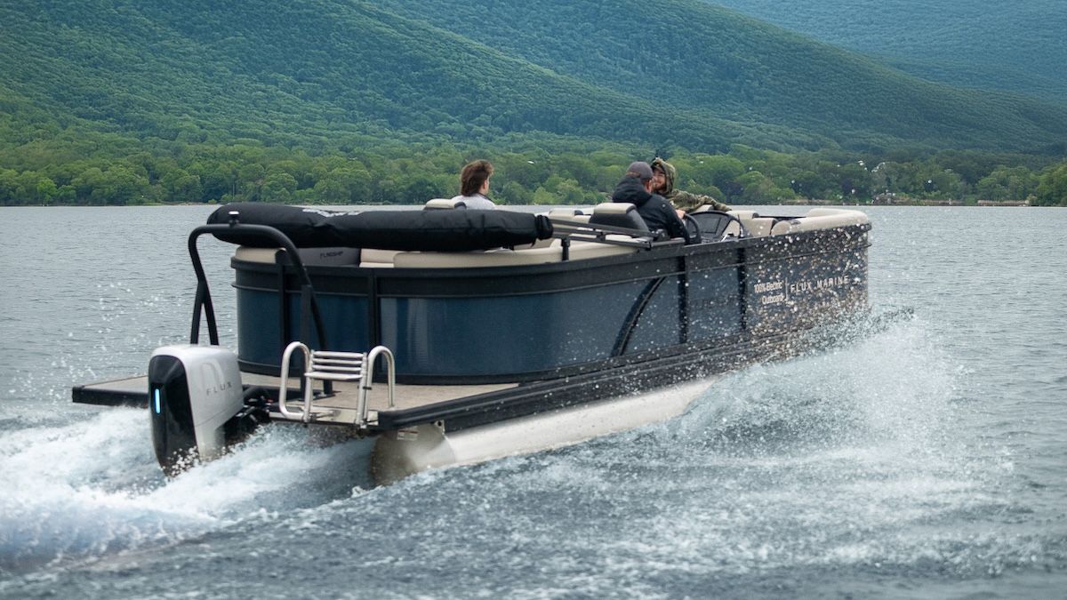 Flux marine powered flagship discover electric pontoon in water man on board