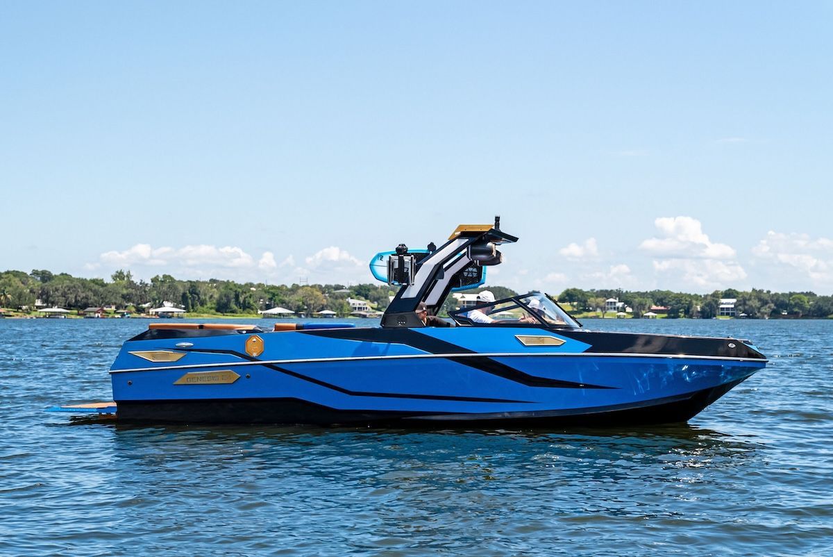 Bright blue hull wakeboard boat in water genesis24