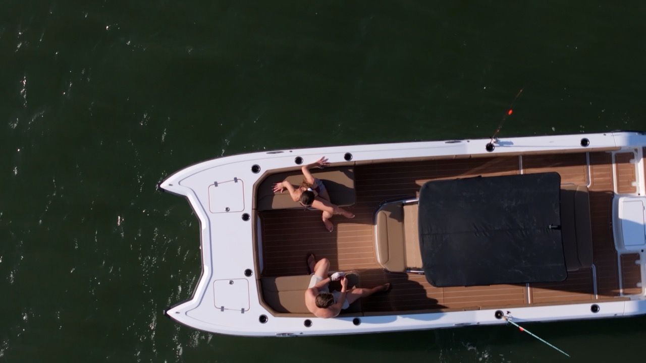 Bow of the artemis23' in water from birds eye view, electric boat