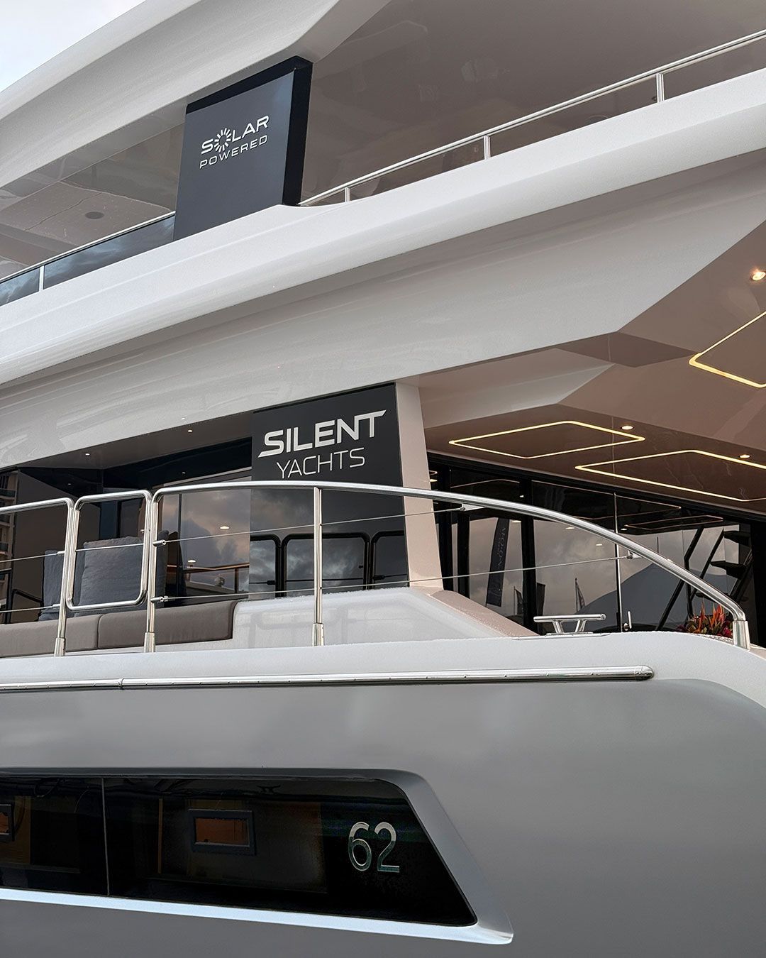 back deck of yacht silent written on sign behind guard rail