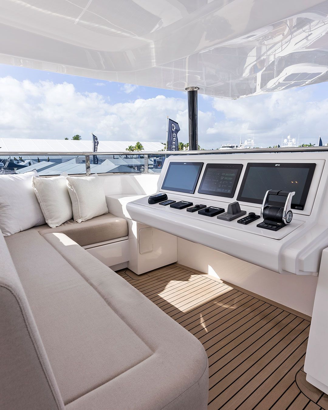 White helm station on a 62 foot yacht with wrapped around seating and cushions 