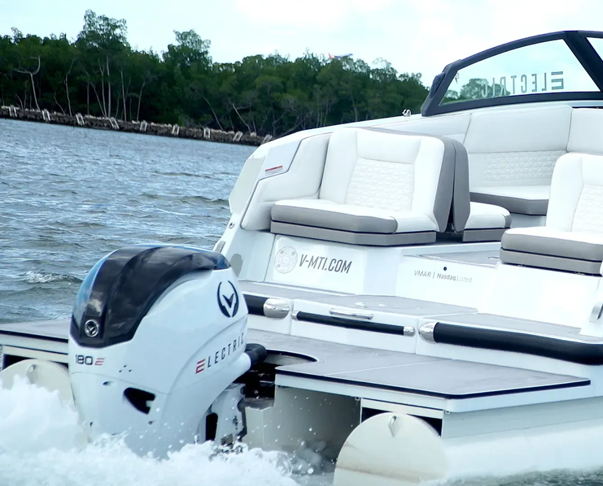 stern transom of the spectr from vision marine technologies white cushion seats and 180e outboard on back