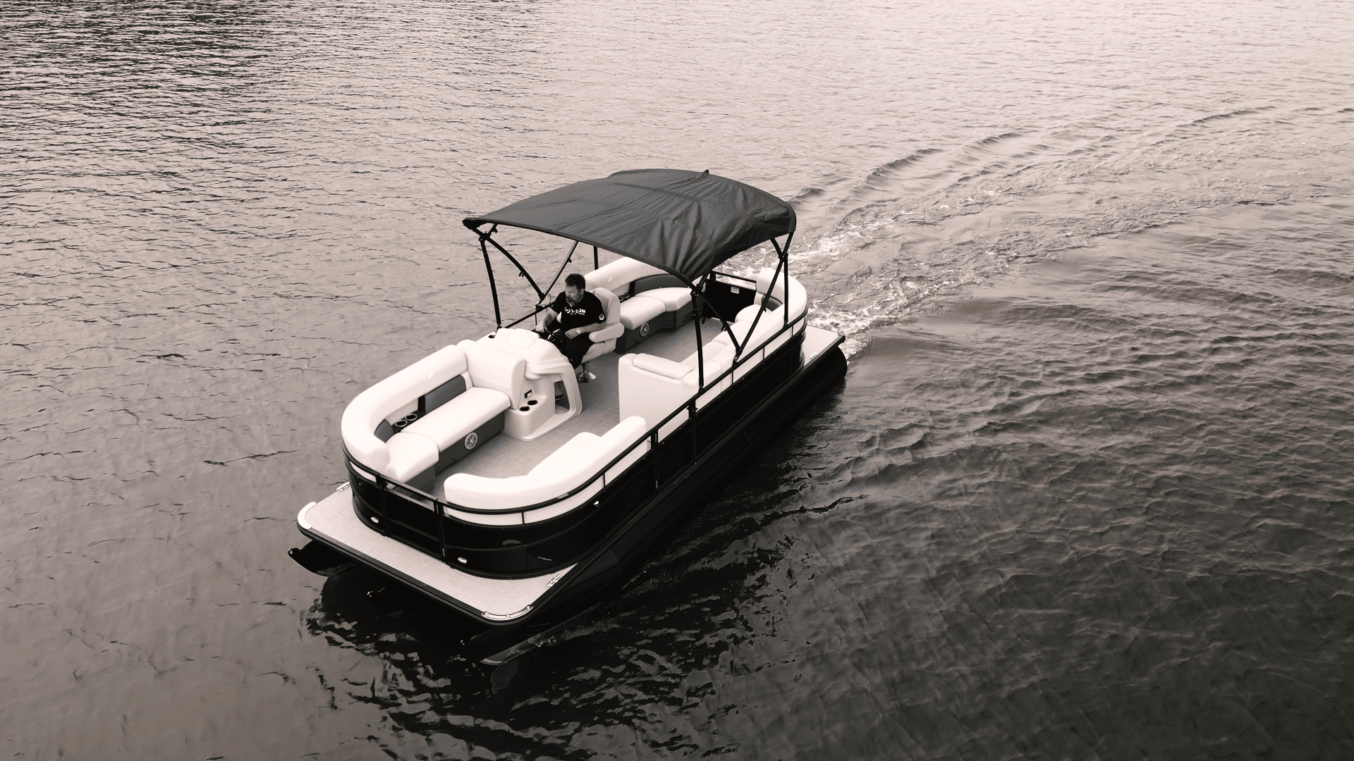 ACEL Joule pontoon electric boat in water with bimini top