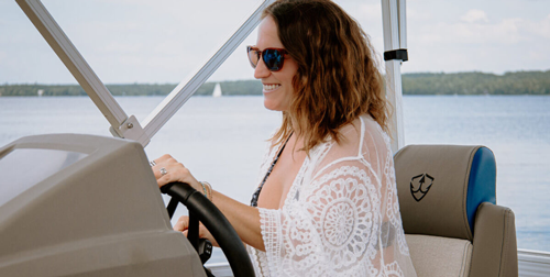 V24 pontoon from Vision Marine 180HP electric pontoon electric deck boat in water people on boat woman making heart symbol with her hand