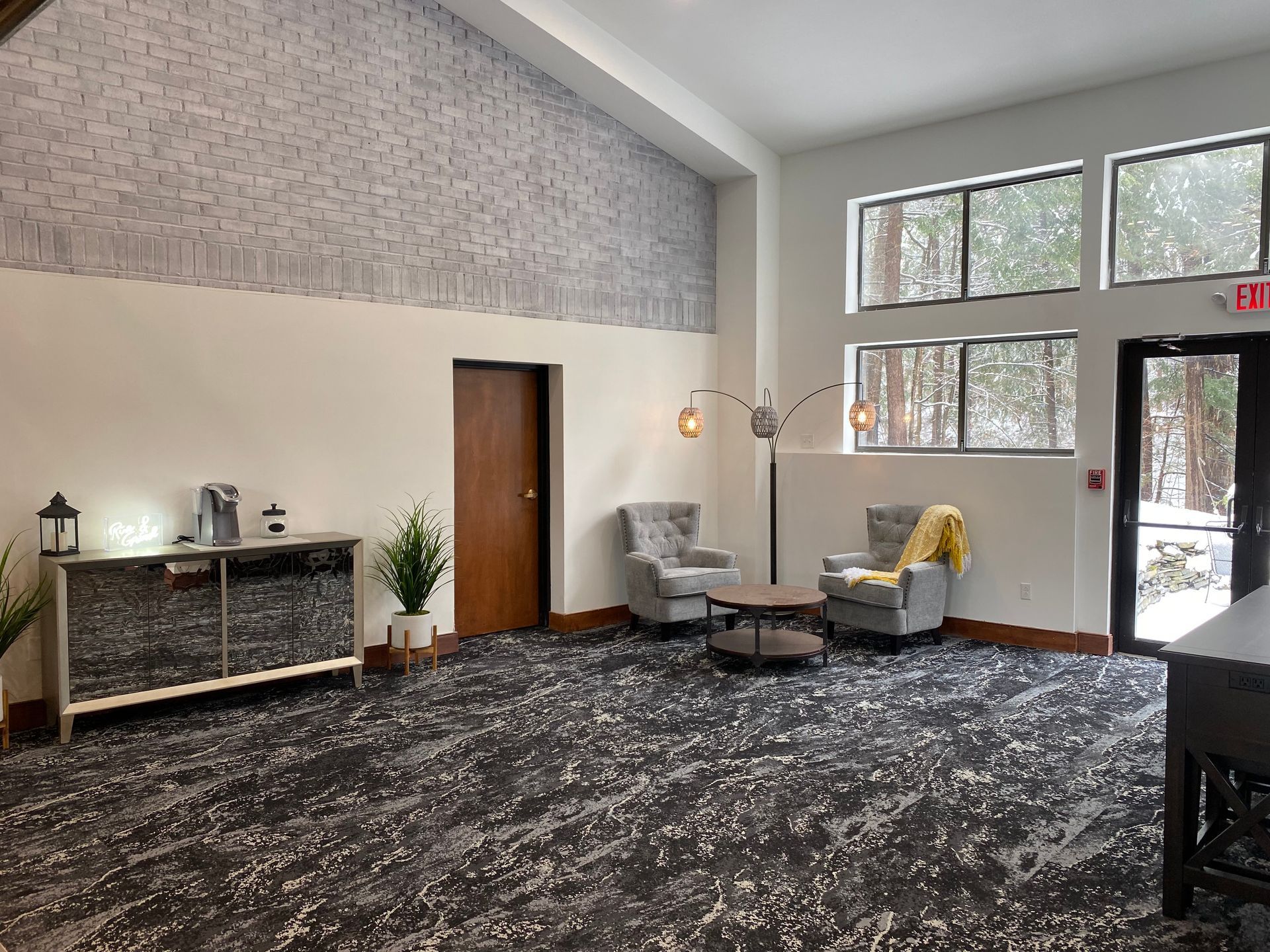 A large room with a lot of windows and chairs in it.