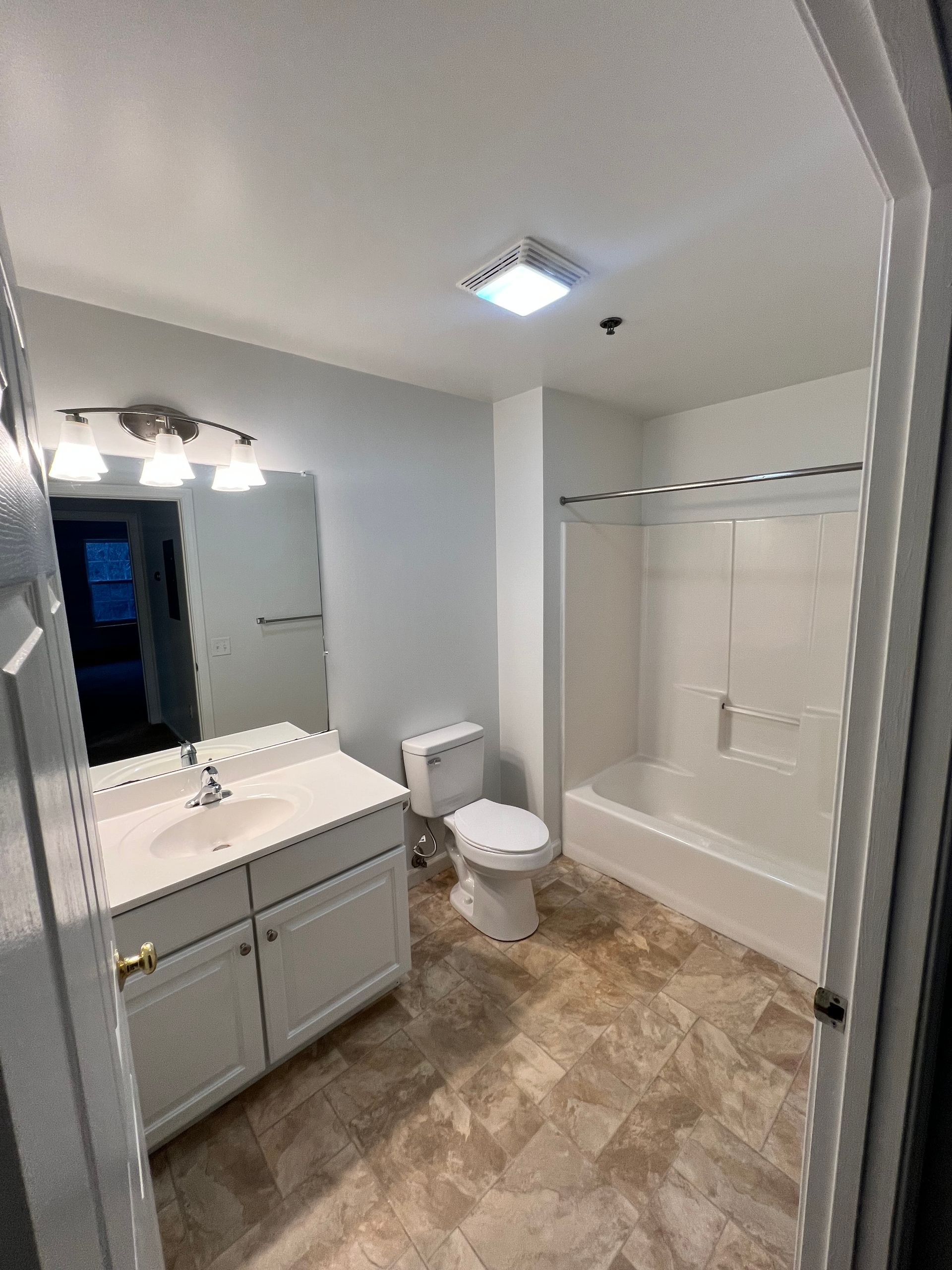 A bathroom with a toilet , sink , and shower.