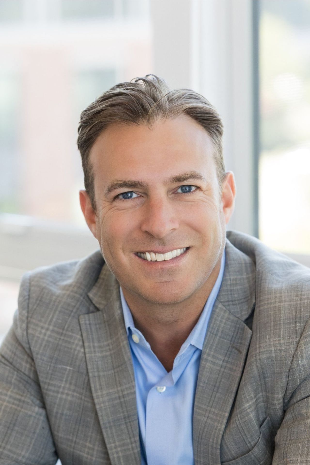 A man with his arms crossed wearing a shirt that says ' america ' on it