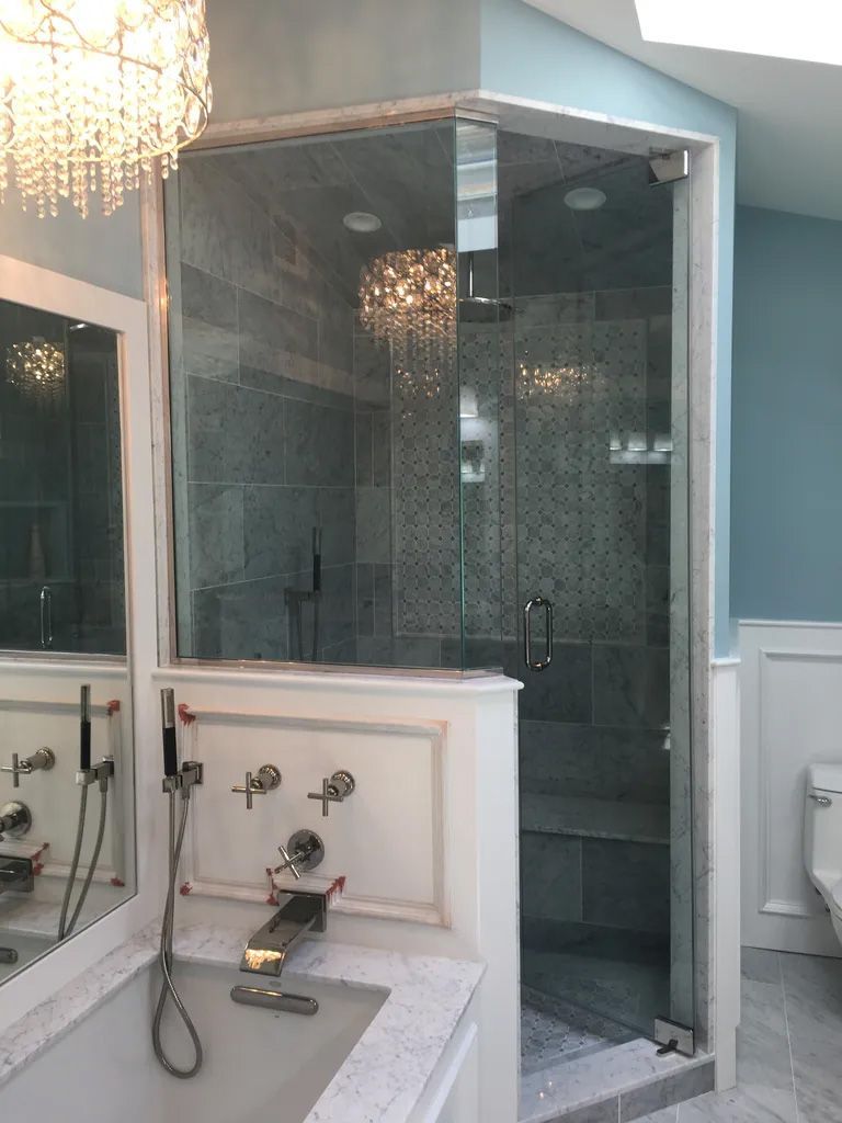 A bathroom with a walk in shower and a bathtub.