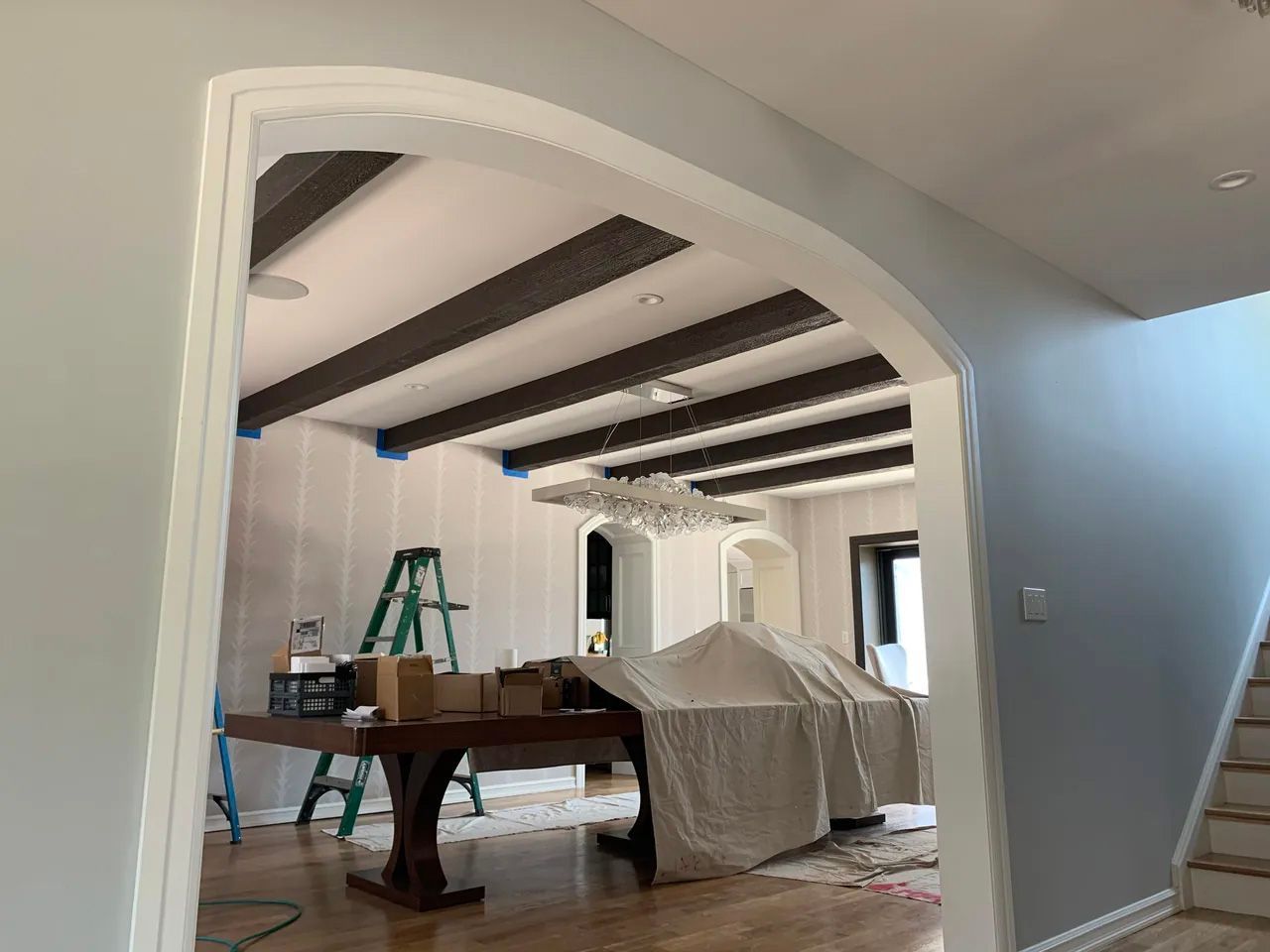 A room with a table and a ladder in it