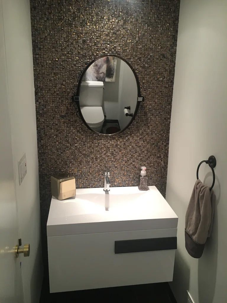 A bathroom with a sink , mirror and toilet.