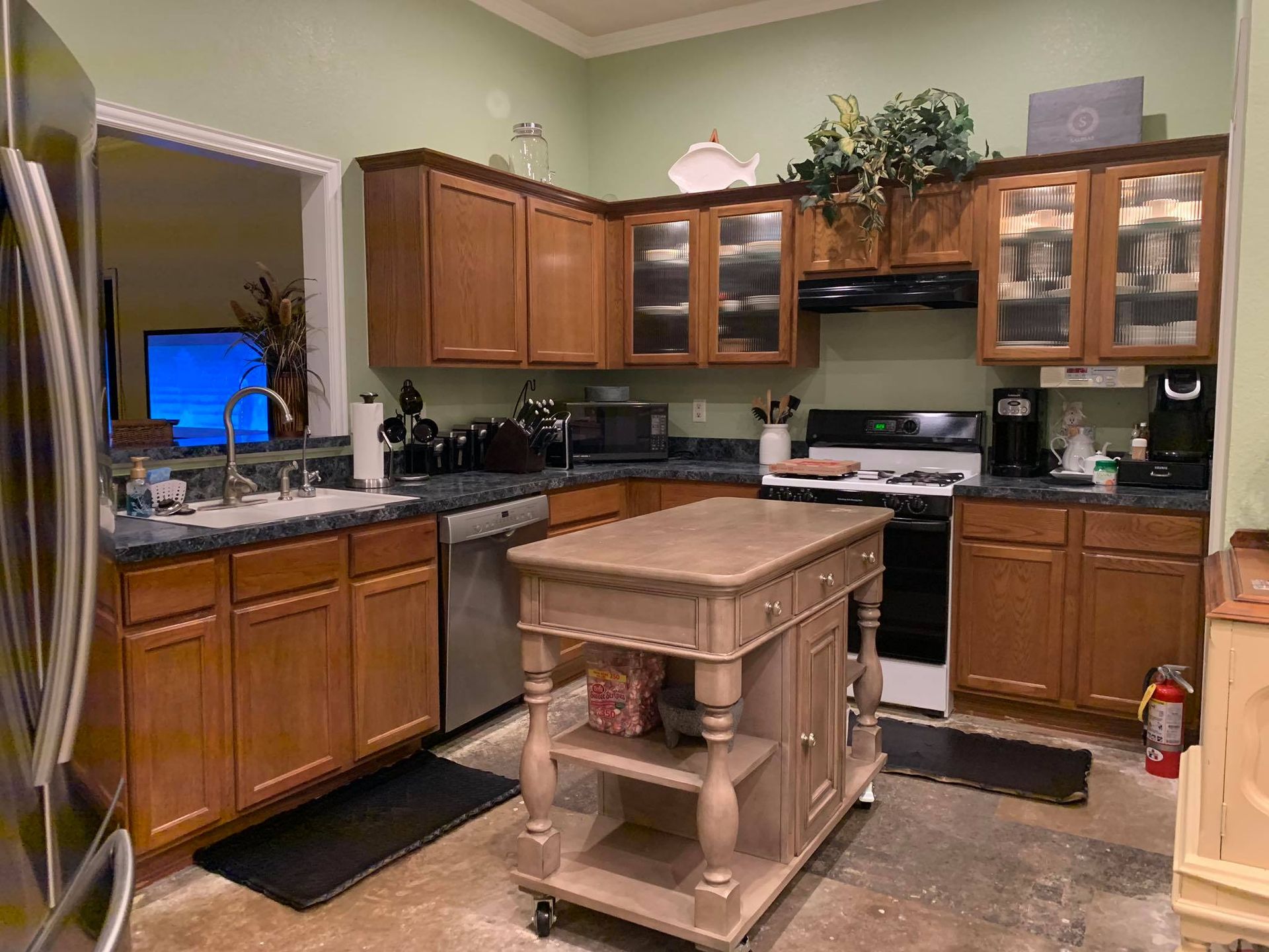 Kitchen with wooden cabinets, stainless steel appliances, and a central island.