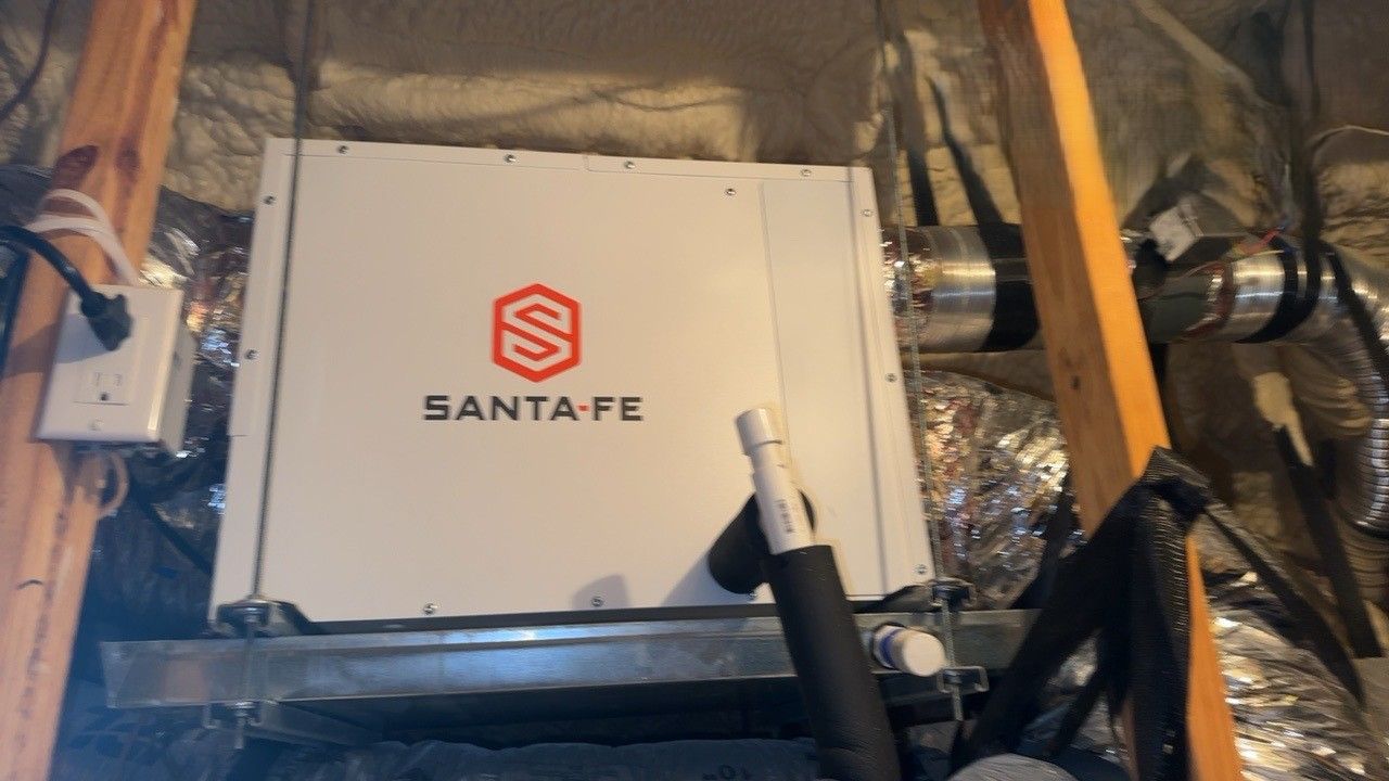 Santa Fe dehumidifier unit installed in an attic.