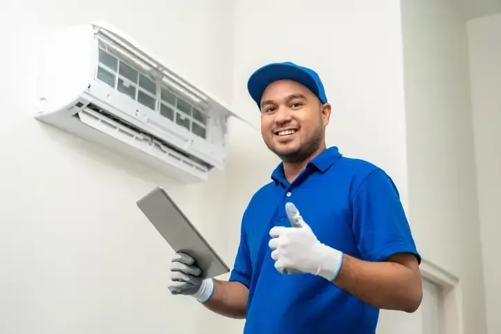 A man from Certified AC Services is repairing the Air conditioner in the Greater Orlando area.