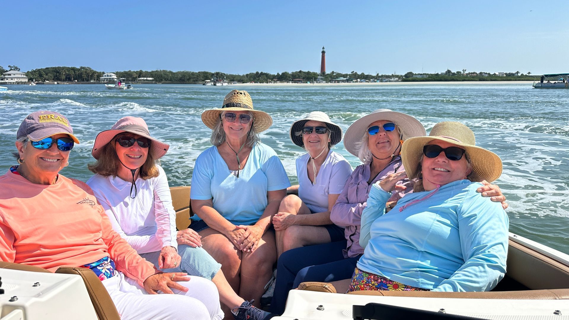 People on a boat, toasting with champagne glasses.